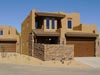 A house with a stone wall and garage door.