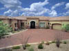 A large driveway with a house in the background.