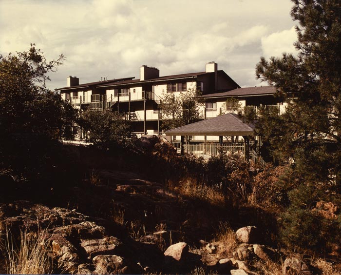 A large building with many windows on the side of it.